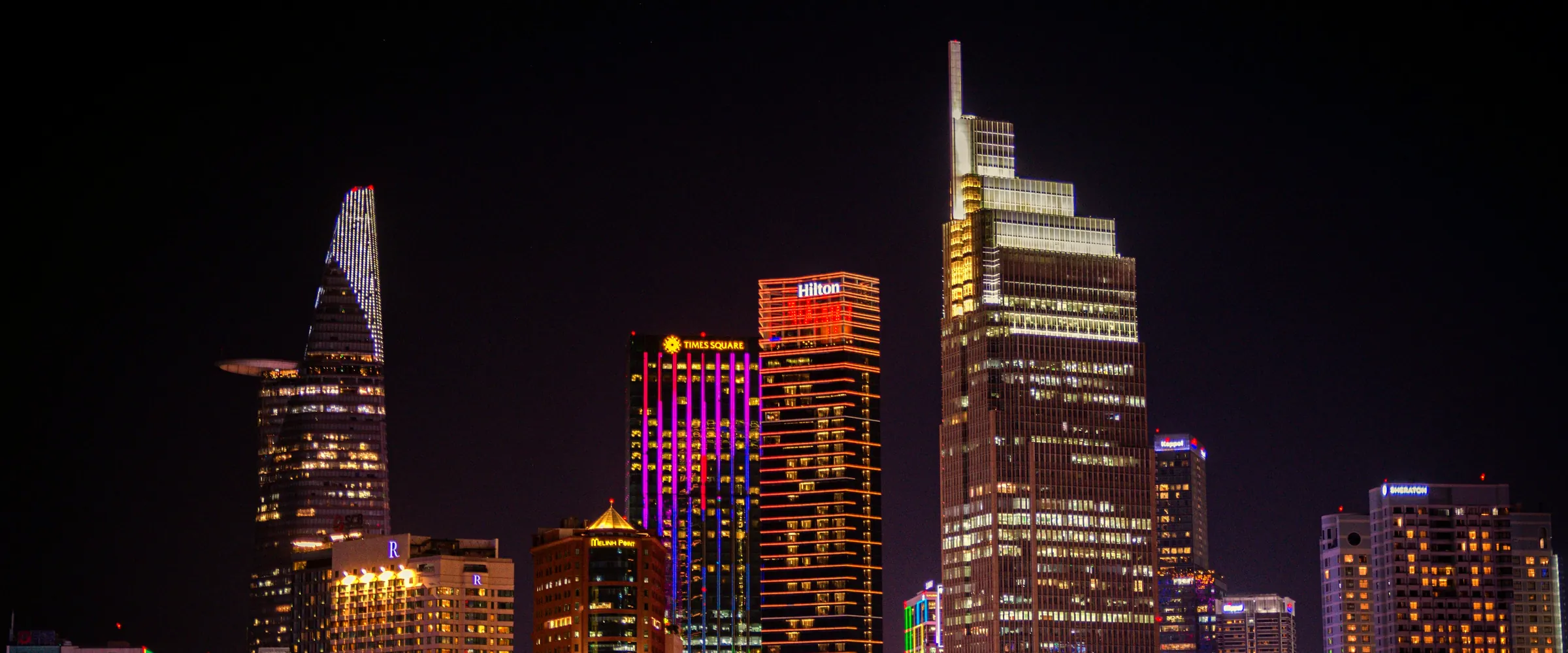 Ho Chi Minh City business district skyscrapers illuminated at night