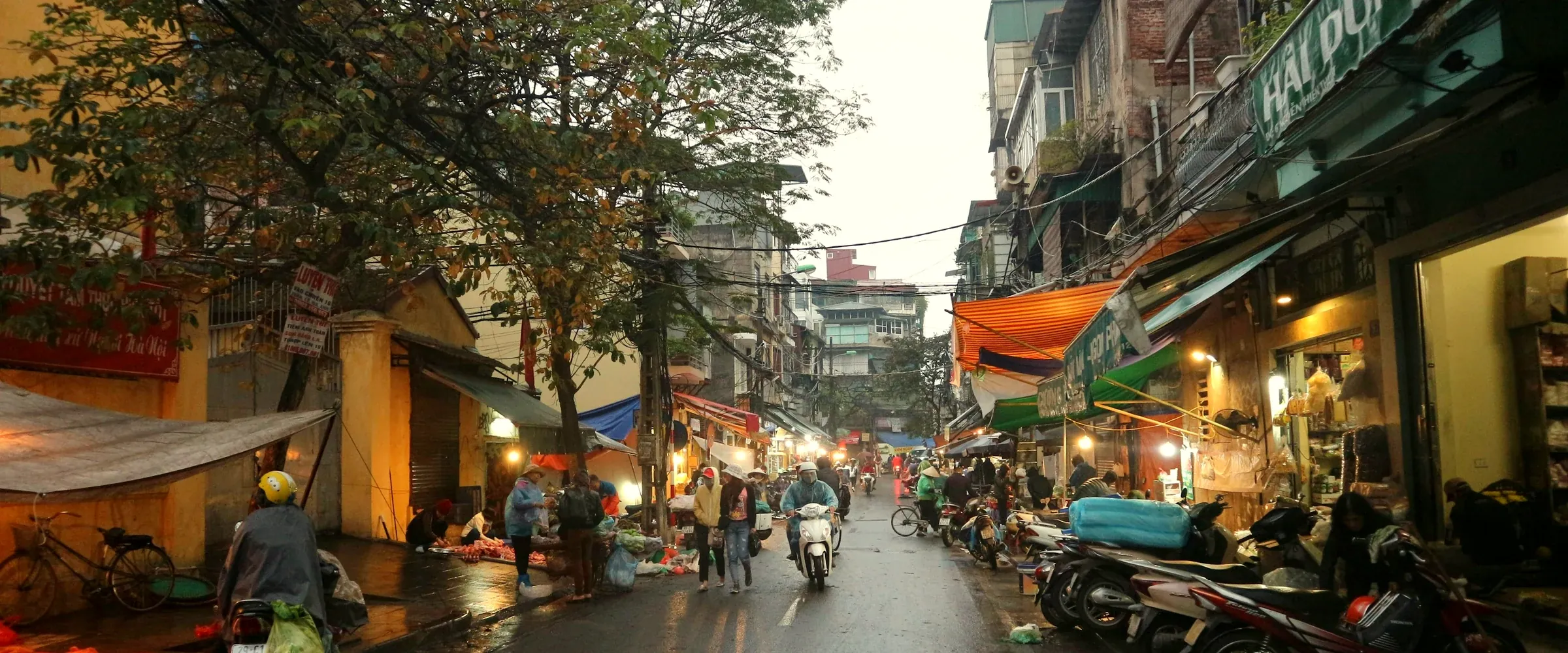 Everyday street scene in Hanoi’s Old Quarter at dusk