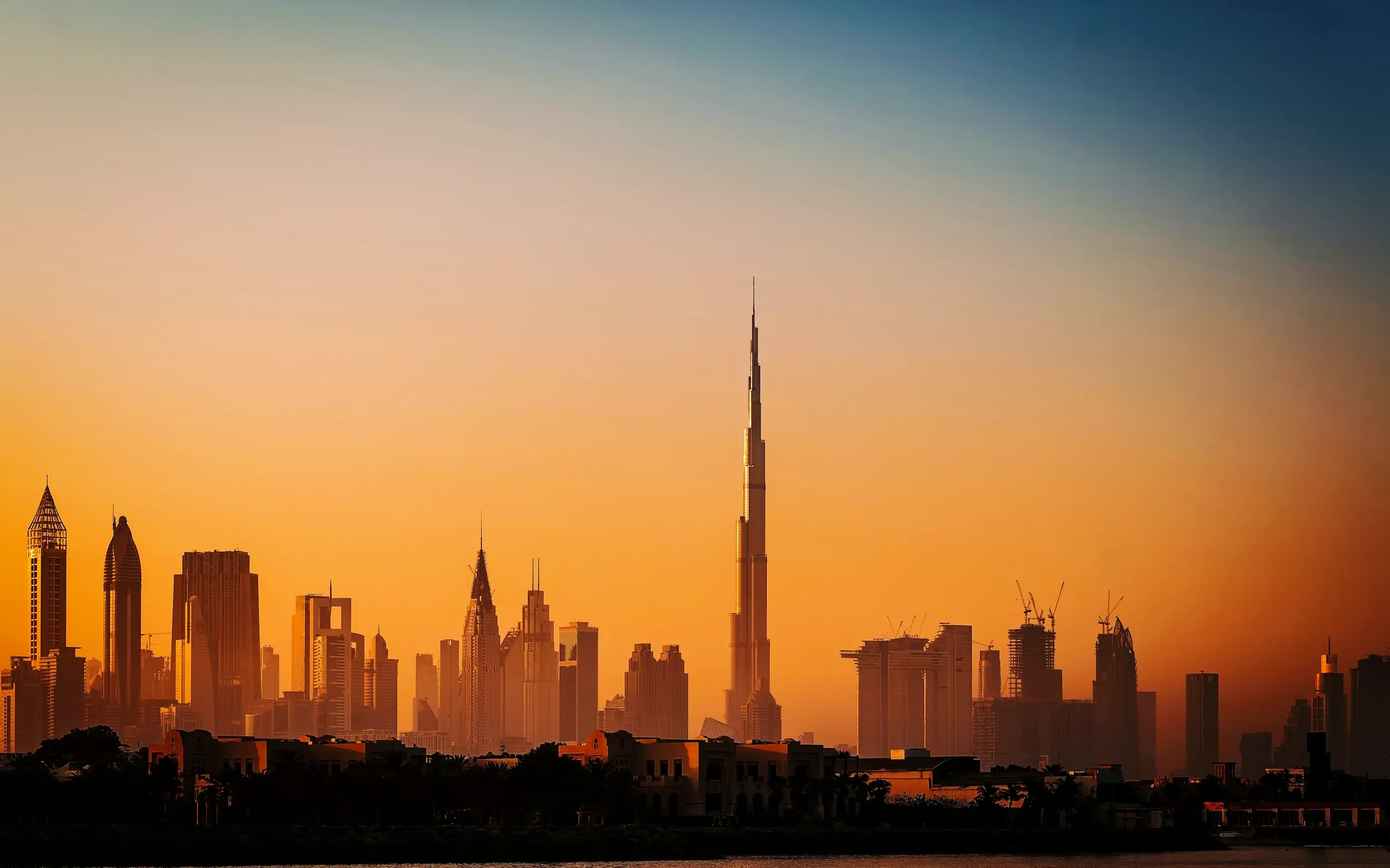 Dubai skyline at sunset across the water